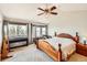 Bright main bedroom features large windows with a seating area, ceiling fan, and ensuite access at 2369 Bayberry Ln, Castle Rock, CO 80104