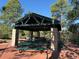 Community park pavilion featuring stone pillars, green picnic tables, and brick ground covering at 2369 Bayberry Ln, Castle Rock, CO 80104