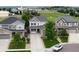 Aerial view of a suburban home with manicured lawn, surrounded by neighboring houses and green spaces at 8071 Tabor St, Arvada, CO 80005