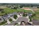 An aerial view of homes in a cul-de-sac with well-manicured lawns and proximity to green spaces and sports fields at 8071 Tabor St, Arvada, CO 80005