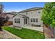 Well-kept backyard with green grass, patio, landscaping, and a privacy fence at 8071 Tabor St, Arvada, CO 80005