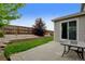 A well-kept backyard featuring a patio, green grass, garden bed, and privacy fence at 8071 Tabor St, Arvada, CO 80005