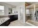 Bathroom featuring a bathtub, shower, and vanity with granite countertops at 8071 Tabor St, Arvada, CO 80005