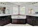 Bright bathroom featuring dual vanities, a corner tub, and tile accents at 8071 Tabor St, Arvada, CO 80005