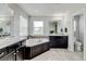 Bright bathroom with double sinks, corner tub, and plenty of counter space at 8071 Tabor St, Arvada, CO 80005
