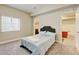Cozy bedroom features a comfortable bed with stylish headboard and natural light from a window at 8071 Tabor St, Arvada, CO 80005