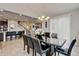 Elegant dining area features an elegant light fixture and seating for six near the kitchen at 8071 Tabor St, Arvada, CO 80005