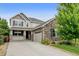 Beautiful two-story home with stone accents, manicured lawn, and a welcoming front porch at 8071 Tabor St, Arvada, CO 80005