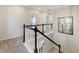 Upstairs hallway with stairs and a decorative mirror at 8071 Tabor St, Arvada, CO 80005