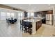 Kitchen flows into dining room with ample counter space, dark cabinets, and stainless appliances at 8071 Tabor St, Arvada, CO 80005