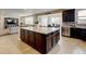 Large kitchen island with cabinets provides extra storage and counter space, flowing into dining room at 8071 Tabor St, Arvada, CO 80005
