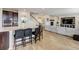 Open concept kitchen with granite island and modern appliances flows into a cozy living room at 8071 Tabor St, Arvada, CO 80005