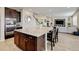 Modern kitchen with a large island flows into a cozy living room at 8071 Tabor St, Arvada, CO 80005