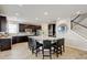 Bright, spacious kitchen features an island with seating and stainless steel appliances at 8071 Tabor St, Arvada, CO 80005