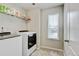 Laundry room featuring a washer and dryer with storage shelves at 8071 Tabor St, Arvada, CO 80005