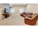 Spacious living area with comfortable leather seating, TV, and modern lighting at 8071 Tabor St, Arvada, CO 80005