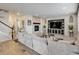 Cozy living room with a stone fireplace, plush sofa, and open layout to the entryway at 8071 Tabor St, Arvada, CO 80005