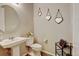 Charming powder room featuring a pedestal sink, stylish mirrors, and decorative accents at 8071 Tabor St, Arvada, CO 80005