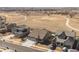 Aerial view of charming one-story home in rural neighborhood with large field in back at 1931 Marlowe W Cir, Erie, CO 80516