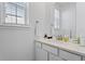 Clean half bath with white cabinetry, white countertop, and modern faucet at 1931 Marlowe W Cir, Erie, CO 80516