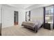 The primary bedroom boasts lots of bright, natural light from the many windows, and neutral colored walls and floors at 1931 Marlowe W Cir, Erie, CO 80516