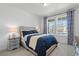 Bright bedroom with a large window and a comfortable bed with blue bedding at 1931 Marlowe W Cir, Erie, CO 80516