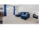 Relaxing bonus room with a comfortable blue sectional, ample natural light, and minimalist decor for versatile use at 1931 Marlowe W Cir, Erie, CO 80516