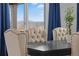 Dining room with an elegant black wood table and padded seating that overlooks a scenic background at 1931 Marlowe W Cir, Erie, CO 80516