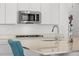 Modern kitchen with stainless steel appliances, white countertops and cabinets at 1931 Marlowe W Cir, Erie, CO 80516
