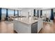 Spacious open kitchen features a large island with barstool seating and overlooks the dining and living areas at 1931 Marlowe W Cir, Erie, CO 80516