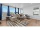 Bright living room featuring an L-shaped couch with colorful throw pillows and a view from the windows at 1931 Marlowe W Cir, Erie, CO 80516