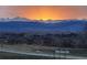 A sunset view of the mountains from across the field at 1931 Marlowe W Cir, Erie, CO 80516