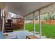 Spacious backyard featuring a covered patio, wooden deck, and large grassy area at 1768 E Jamison Ave, Centennial, CO 80122