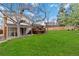 Wide open green backyard with a covered patio and wooden deck, excellent for gatherings at 1768 E Jamison Ave, Centennial, CO 80122