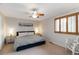 Bright bedroom features a king-sized bed, ceiling fan and a window with wood shutters at 1768 E Jamison Ave, Centennial, CO 80122
