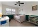 Bright bedroom featuring a ceiling fan, plantation shutters, and neutral decor at 1768 E Jamison Ave, Centennial, CO 80122