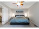 Bright bedroom with a king-sized bed, ceiling fan and modern bedside tables at 1768 E Jamison Ave, Centennial, CO 80122
