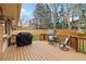 Outdoor deck with wood railings, grill, and seating area, perfect for entertaining at 1768 E Jamison Ave, Centennial, CO 80122
