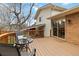 Wooden deck with sliding glass door access to the home and outdoor seating area at 1768 E Jamison Ave, Centennial, CO 80122