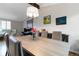 Open concept dining area featuring stylish table, comfortable seating, modern light fixture, and hardwood floors at 1768 E Jamison Ave, Centennial, CO 80122