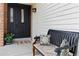 Welcoming front porch with a comfortable bench and black front door, adding curb appeal to the home at 1768 E Jamison Ave, Centennial, CO 80122