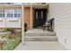 Inviting front porch with seating, attractive landscaping, and brick and siding exterior at 1768 E Jamison Ave, Centennial, CO 80122