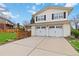 Attached two-car garage with white doors and adjacent to a well-maintained lawn and neutral colored siding at 1768 E Jamison Ave, Centennial, CO 80122