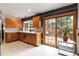 Bright kitchen featuring wood cabinets, stainless steel appliances, and sliding glass door to the deck at 1768 E Jamison Ave, Centennial, CO 80122