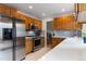 Updated kitchen with stainless appliances, wooden cabinets and view to the dining room at 1768 E Jamison Ave, Centennial, CO 80122
