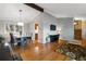 Open-concept living and dining area with hardwood floors, vaulted ceiling, and contemporary decor at 1768 E Jamison Ave, Centennial, CO 80122