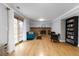 Open living room with hardwood floors, brick fireplace, access to an outdoor patio, and built-in bookcase at 1768 E Jamison Ave, Centennial, CO 80122