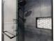 Modern shower with gray tiling, frameless glass, and convenient built-in niche at 1768 E Jamison Ave, Centennial, CO 80122