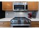 Modern stainless steel stove and microwave appliances in a stylish kitchen with ample cabinetry at 1768 E Jamison Ave, Centennial, CO 80122