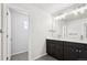Bathroom with double vanity, granite countertops and dark cabinets at 8787 Whiteclover St, Littleton, CO 80125